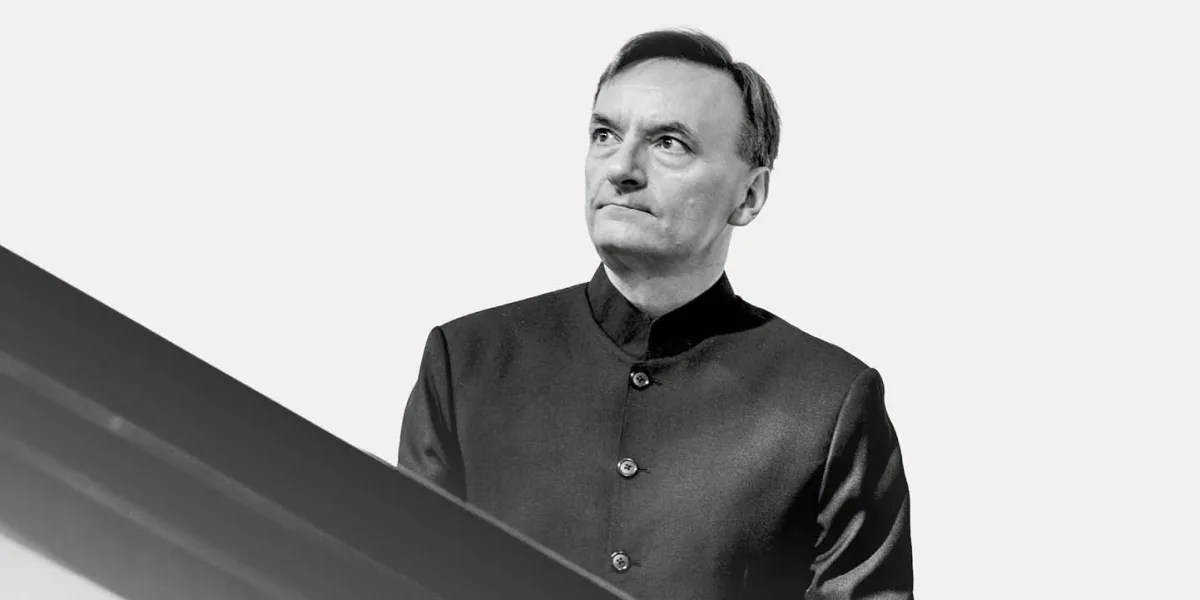 Sir Stephen Hough looks to the right at his piano